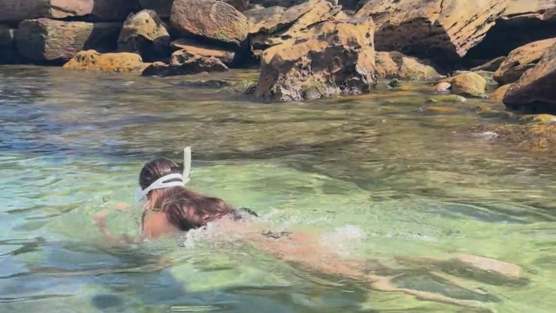 Video compilation of girls snorkelling in shallow waters on the beach